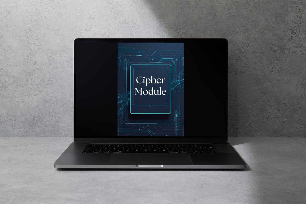 A dark gray laptop sits open on a light gray surface against a textured gray wall, with its screen displaying a blue graphic that reads 'Anchor Guide'.